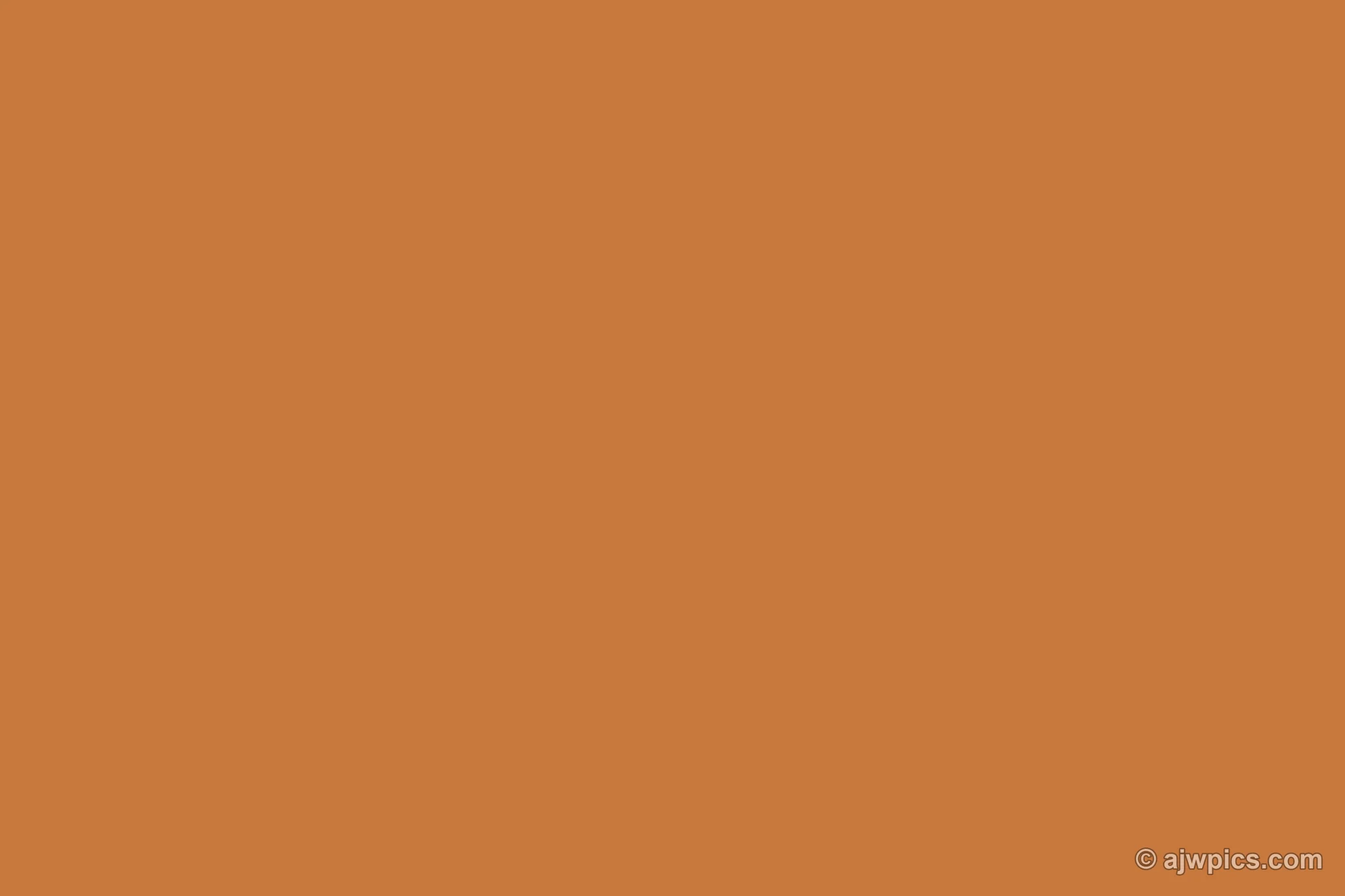 An orange sunset over sand dunes